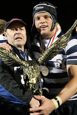 Team Captain Steve St. Pierre and former Coach John Seggar pose with the National Championship trophy