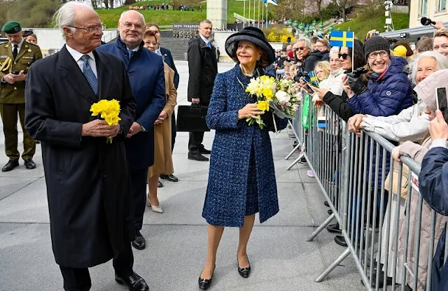 Queen Silvia wore a navy tweed coat, tweed jacket and navy tweed dress by Chanel. Mrs Sirje Karis and Prime Minister Kaja Kallas