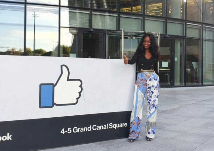Woman standing in-front of Facebook HQ