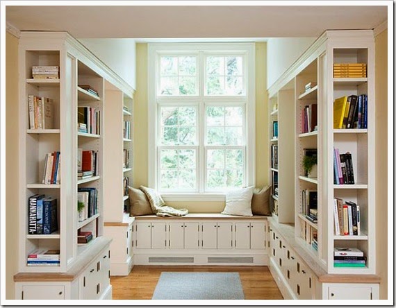 Traditional-home-library-with-cozy-reading-nook-White-Bookcase-Also-Showing-the-Window-Seat-Decorated-with-Cream-and-White-Pillows