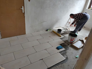 Bekir cracking on with the tiling