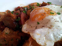 Panfried chorizo, white beans and crispy pork belly with spanish onion and fried egg