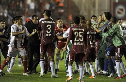 Fluminense and Argentinos Juniors players fight at the end of a Copa Libertadores match