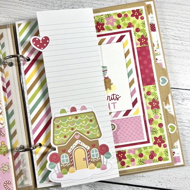 Christmas scrapbook album page with folding element, journaling card, flowers, and a gingerbread house