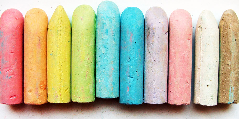 rainbow coloured pieces of chalk lied in a row