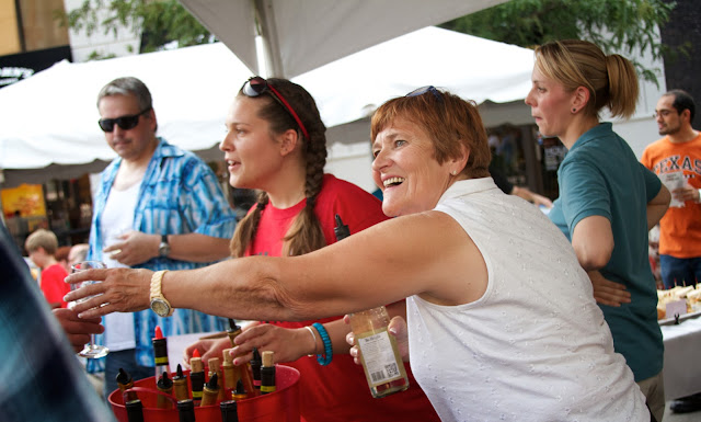 Taste of Downtown in Lansing, Michigan. Volunteers serve wine samples.