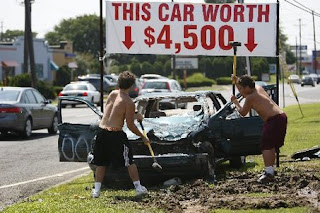 Cash For Clunkers Destruction Performance Art by two kids with  sledge hammers