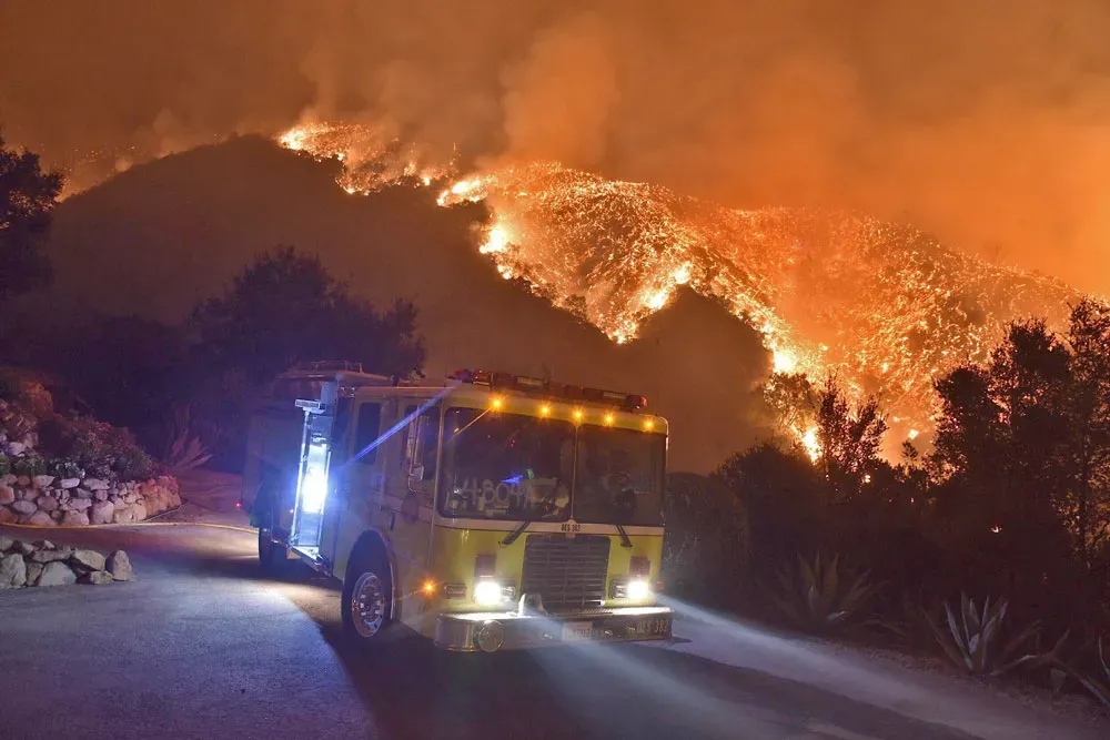 A fire engine stands ready for structure protection in Romero Canyon on Dec. 12, 2017, during the destructive Thomas Fire.  Ryan Cullom / Noozhawk file photo