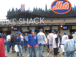 in front of Shake Shack and the skyline from Shea Stadium