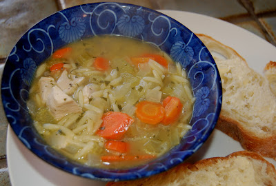 Chicken vegetable soup with orzo, served with buttered rustic baguette