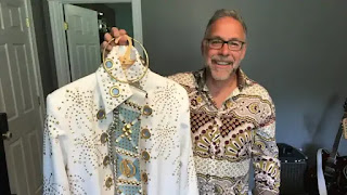 Mike Bravener holds up one of his prized Elvis-style jumpsuits. (Matthew Bingley/CBC)