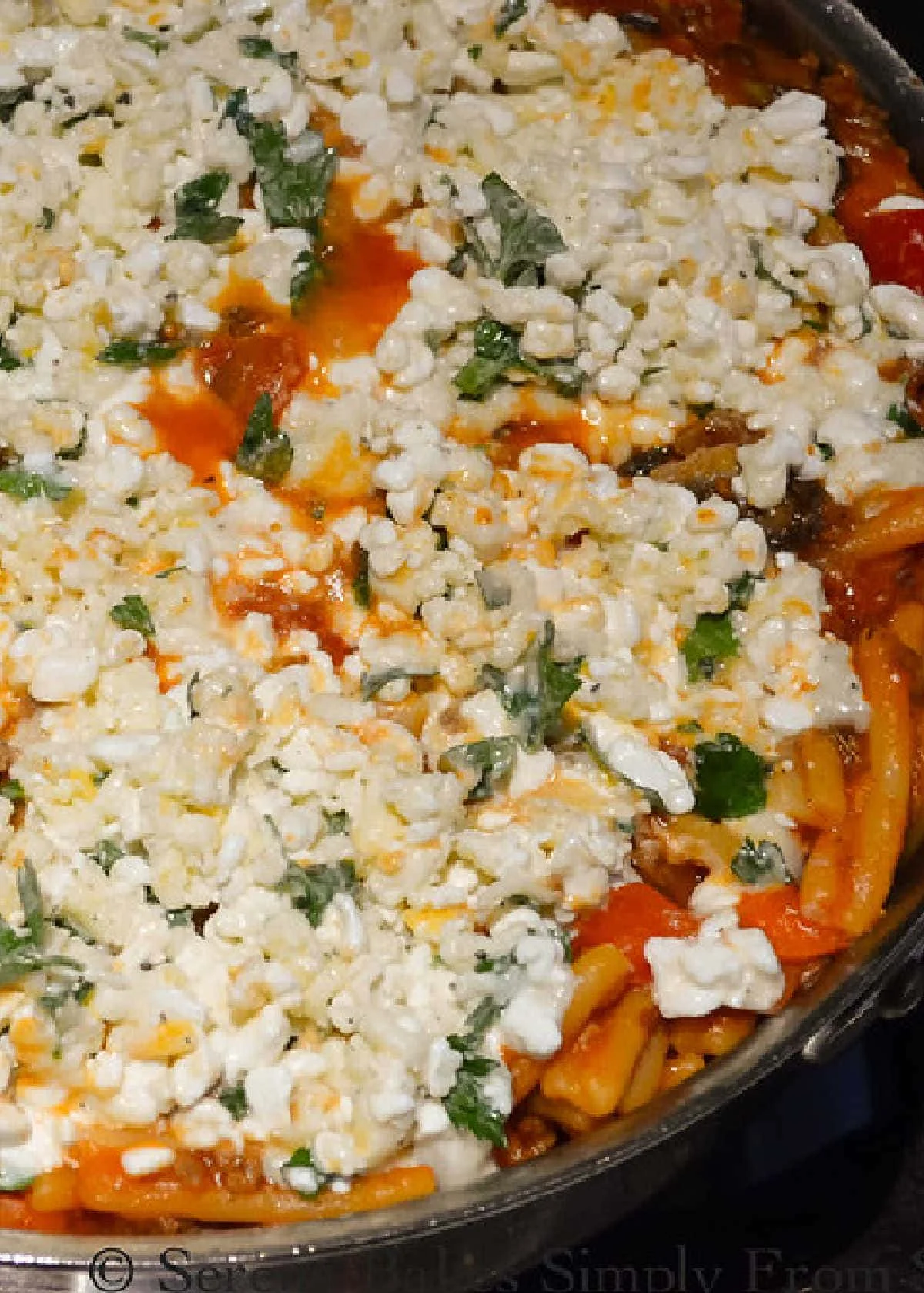 Easy One Pot Lasagna covered with cottage cheese mixture in a stainless steel pot.