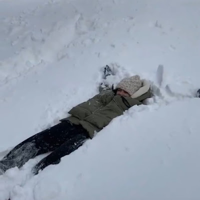 Actress Lucy Hale making a snow angel