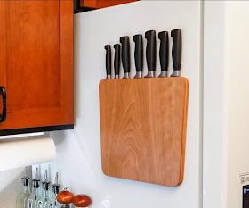 wood knife rack attached to the side of a refrigerator