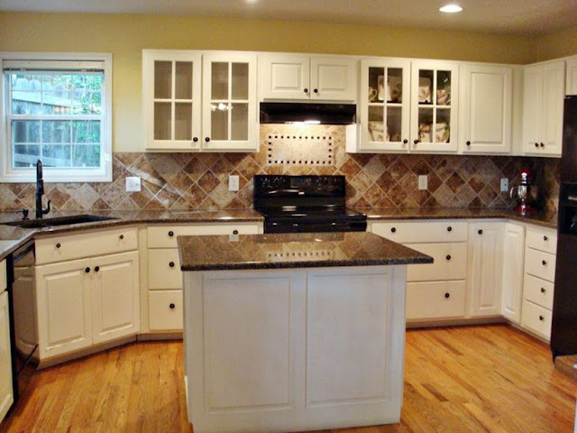 white kichen cabinets with brown granite countertops