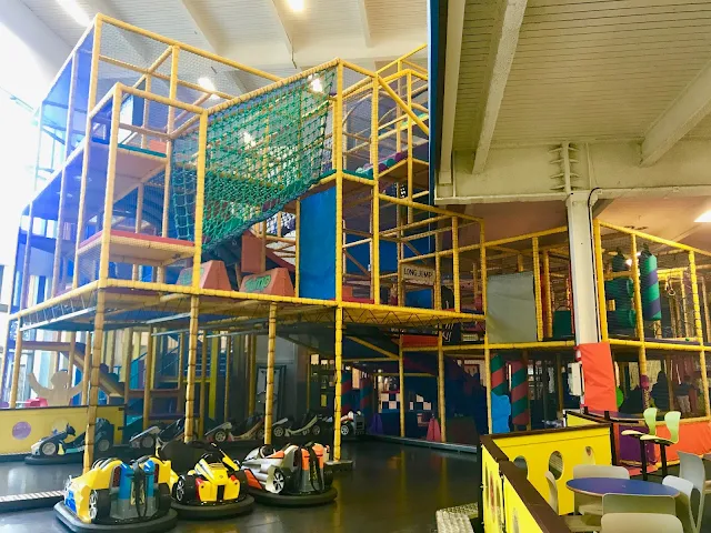 A view of a 4 story soft play frame with dodgems in the foreground