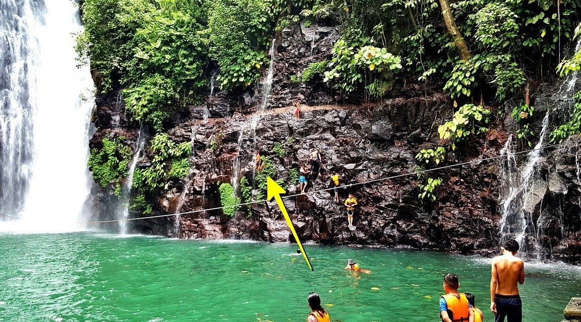 boys jumping from the right side cliff of Tinago Falls