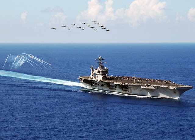  F/A-18 Hornets and Super Hornets from Carrier Air Wing (CVW) 2 fly in formation during an air power demonstration above the Nimitz-class aircraft carrier USS Abraham Lincoln (CVN 72).