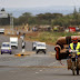 In Nairobi, Kenya, a man carries sofa on motorcycle.  