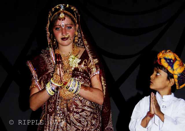 Bridal Competetion for Tourists @ Pushkar Camel Fair - 2008: While visiting Pushkar, I chanced upon a Bridal Competition where young foreign girls dressed in beautiful Indian bridal dresses, contemporary and traditional. Till very recent past, it was a norm to use maroon (a deep red) fabric for a bridal dress in north India. However, recently, designers and brides have started experimenting with new colors, such as Golden, Green, Orange etc.: Posted by VJ on PHOTO JOURNEY @ www.travellingcamera.com : VJ, ripple, Vijay Kumar Sharma, ripple4photography, Frozen Moments, photographs, Photography, ripple (VJ), VJ, Ripple (VJ) Photography, VJ-Photography, Capture Present for Future, Freeze Present for Future, ripple (VJ) Photographs , VJ Photographs, Ripple (VJ) Photography : A Stunning Bride in a Brown Lehenga with Golden Lace Work. The young man next to her cannot take his eyes off her face.