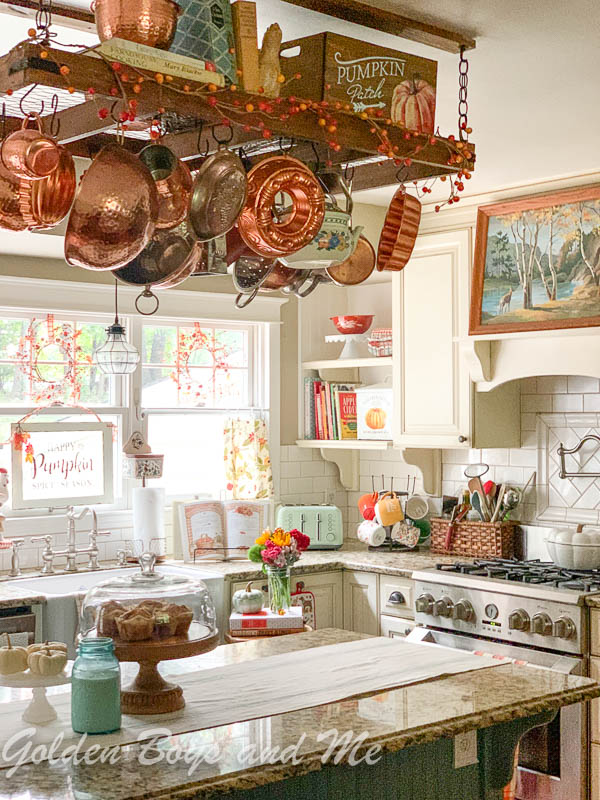Cottage style kitchen with pot rack and farmhouse sink - www.goldenboysandme.com
