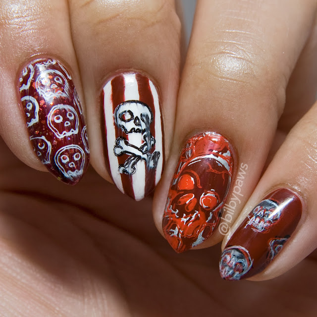 Skull-themed Halloween Nail art @bilbypaws in shades of red and white