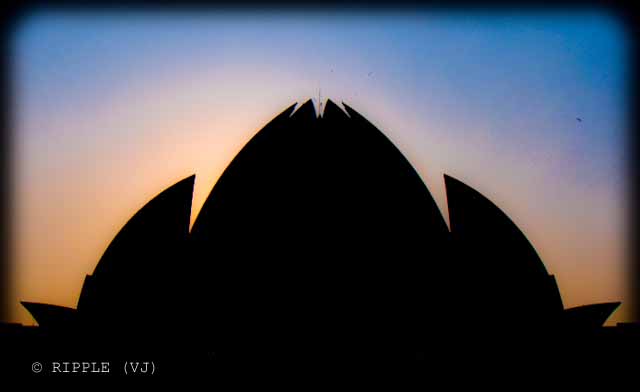 Sunset View @ Lotus Temple, Nehru Place, Delhi: The Baha'i House of Worship in Delhi which is popularly known as the Lotus Temple due to its flower like shape, is a Bahai House of Worship and also a prominent attraction in Delhi. It was completed in 1986 and serves as the Mother Temple of the Indian subcontinent. It has won numerous architectural awards and been featured in hundreds of newspaper and magazine articles.: Posted by Ripple (VJ) on PHOTO JOURNEY @ www.travellingcamera.com : ripple, Vijay Kumar Sharma, ripple4photography, Frozen Moments, photographs, Photography, ripple (VJ), VJ, Ripple (VJ) Photography, Capture Present for Future, Freeze Present for Future, ripple (VJ) Photographs , VJ Photographs, Ripple (VJ) Photography : Sun behind Lotus Temple throwing nice colors in the sky... I love this combo of Orange and Blue.. Although its hard to find these colors in Delhi but I was fortunate enough to catch it in my Camera :-)Lotus Temple is one of the most beautiful temples of India. Lotus Temple stands seventh in the international chain of Bahai House of Worship. Lotus Bahai Temple is considered as the Mother Temple of the Indian Continent. The splendid architecture of the temple has been accredited with several architectural awards.