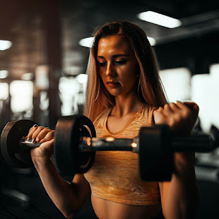 Pretty woman doing weights in the gym