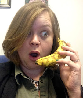 April's shocked face talking on a banana as a phone