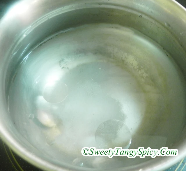 Saucepan with water, oil, and salt heating on a stovetop.