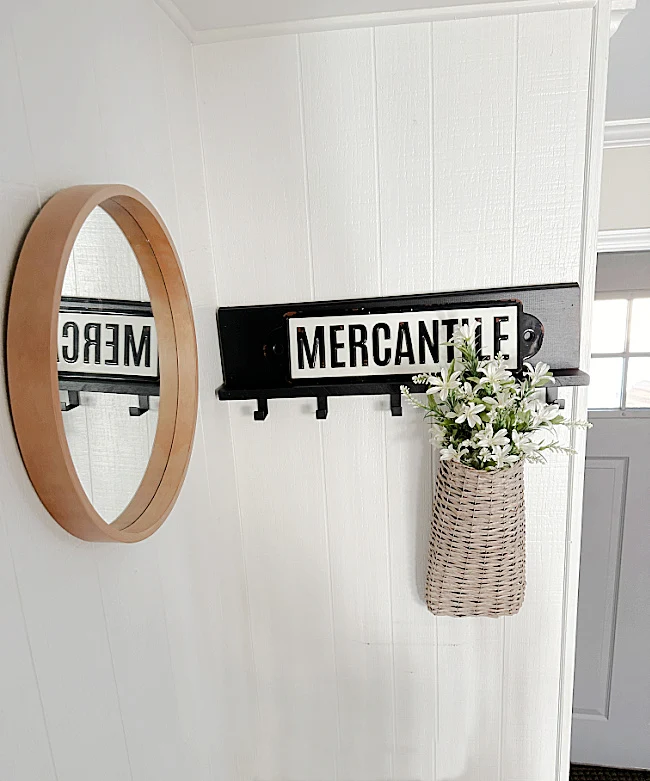 entryway with mirror and coat rack