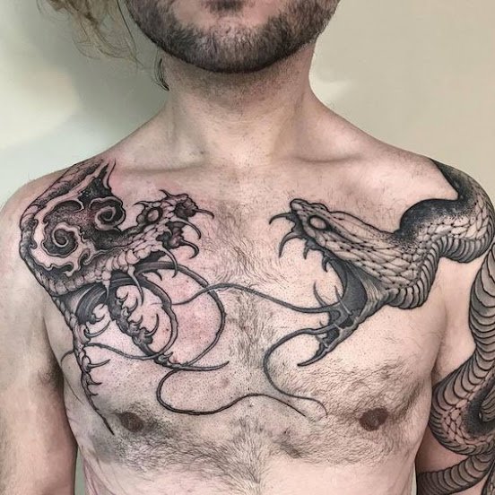 snake-vs-snake-on-men's-chest-tattoo