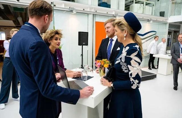 Queen Maxima wore a new stretch wool long sleeve embossed dress by Oscar de la Renta, and navy wool coat by Natan