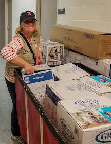 Jeanne-Aimee De Marrais, Save the Children’s senior director for U.S. emergencies, wheels a load of portable cribs for babies into a Salvation Army shelter for homeless families impacted by Hurricane Harvey in Texas. 