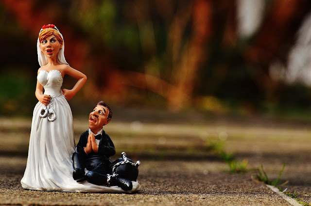 Funny figures of bride and groom arguing 