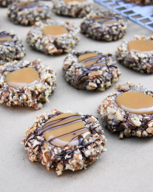Insanely Delicious Turtle Cookies ... soft chocolate-pecan thumbprint cookies filled with caramel.  Yum! www.thekitchenismyplayground