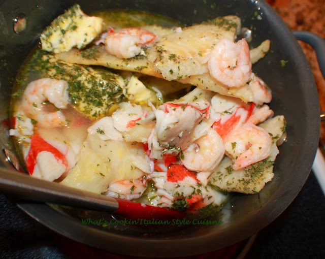 seafood in a pan of white wine sauce