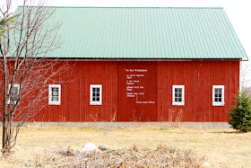 does the red barn hold a red wheelbarrow?