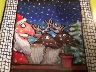 Santa and reindeer peeking through the window