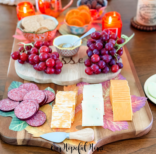 sliced summer sausage precut cheese red grapes charcuterie board