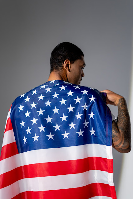 Man with an American flag cape