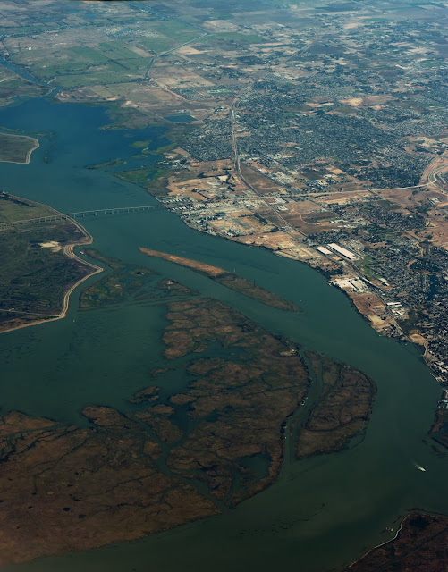 An aerial photo of a bridge spanning a channel and island in the US.