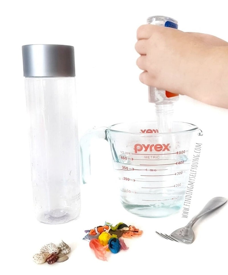 adding glue to a sensory bottle