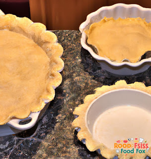 This image shows the prepared pie crusts, one being placed into the pie dish and the other rolled out on top of the filling. The crusts are golden brown and flaky.