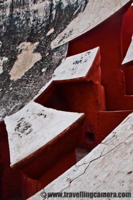 Some Experiments with old architecture of Jantar Mantar in Delhi, INDIA : Posted by VJ SHARMA on www.travellingcamera.com : Last month me and one of my friend were waiting for other folks to reach Connaught Place in Delhi and they called us to inform that all of them are arriving after 1:30 Hrs... This was good opportunity for us to explore some place nearby and decided to visit Jantar Mantar... After reaching the place I was not able to decide what should I shoot... Everywhere people were roaming and it was really difficult to find a place without people... and it was not like two or three folks.. It was huge crowd in front of each yantra @ Jantar Mantar.. So finally I decided to have some photographs which can avoid this crowd and it gave a good opportunity to place with various angles/compositions... check out and critics are welcome !!The first photograph where I wanted to have darkest possible shadows to make it look like black tiles in contact with reds and white ones.. Although it doesn't look like that... I would have to wait to click this photograph at right time but we had to move out in few hrs... Never mind, I will try it again...This time I was carrying SONY Alpha-700 and was confused with some of the controls.. Anyway that's not important... These yantras were very narrow is shape and it was difficult to fit myself for clicking these architecture forms nicely... Here is a tilted view of a semi-spherical yantra @ Jantar Mantar...All these photographs from the same yantra and it was was quite interesting... But please don't ask me about how it functions and what it is supposed to do...Stairs hidden behind these structures and everyone needs to follow them to go down and see the real work inside these yantras.. In Jantar Mantar at jaipur, everyone was not allowed to go inside these structures but in Delhi I didn't see such restrictions except one which had highest structure followed by lot of stairs....Jantar Mantar in Delhi is a very popular place among activists, social associations and artists as well... Many of the NGOs choose this place to start a rally or protest... Also many artists have explored this very well and many times Photographers have exhibited this place...A Series of small pillars taking all the weight of small paths connecting outer circle of a structure with a pole in the middle... as you can see the turning path in a circle...One of my friend called it 'Stairs of Success'.. I don't if that is the name of these stairs but like the caption :)Final Photograph showing the close-up view of this architecture which shows the age of this structure and its been repaired multiple times in past which resulted in this roughness... I am again planning to visit Jantar Mantar in Delhi and will ensure that I get full day to spend there...