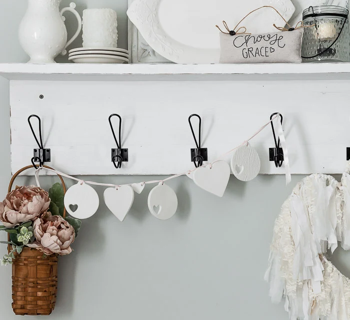 white wood shelf, black hooks, ironstone stacks, blush flowers