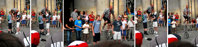 Five photos of various stages of Shane helping the street performer get on his tall unicycle.