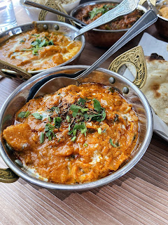 The photo shows a picture of the Indian dish Curry Madras from Indian by Nature in Paisley. Vegan food served in a small bowl
