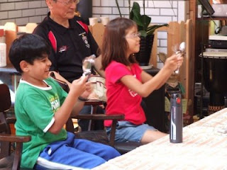 Children playing spoons in special music lesson at International School of Bangkok