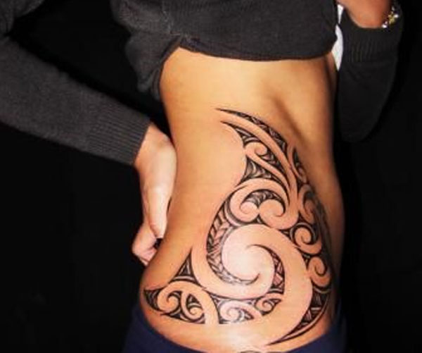 This tribal tattoo design idea is very popular and fashionable for the girls side stomach